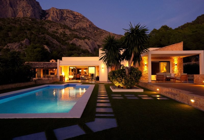 a residential house with a pool and a great landscape