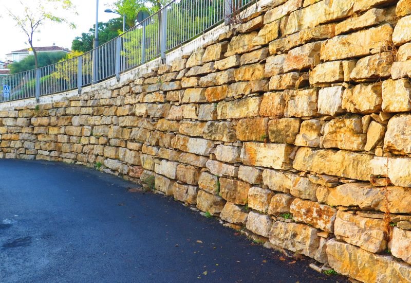 a retaining wall beside the street