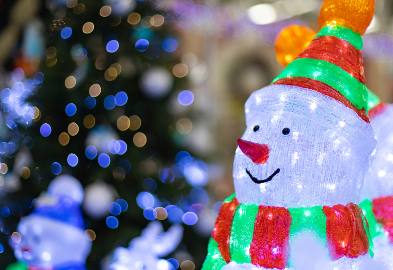 a white snowman with lights for christmas lighting design
