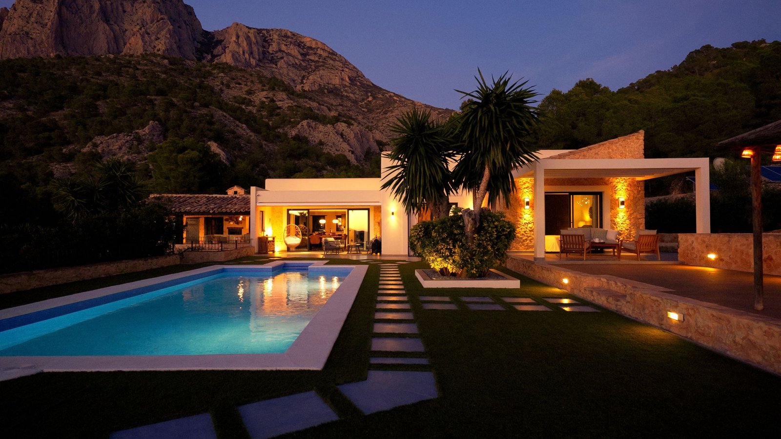 a residential house with a pool and a great landscape