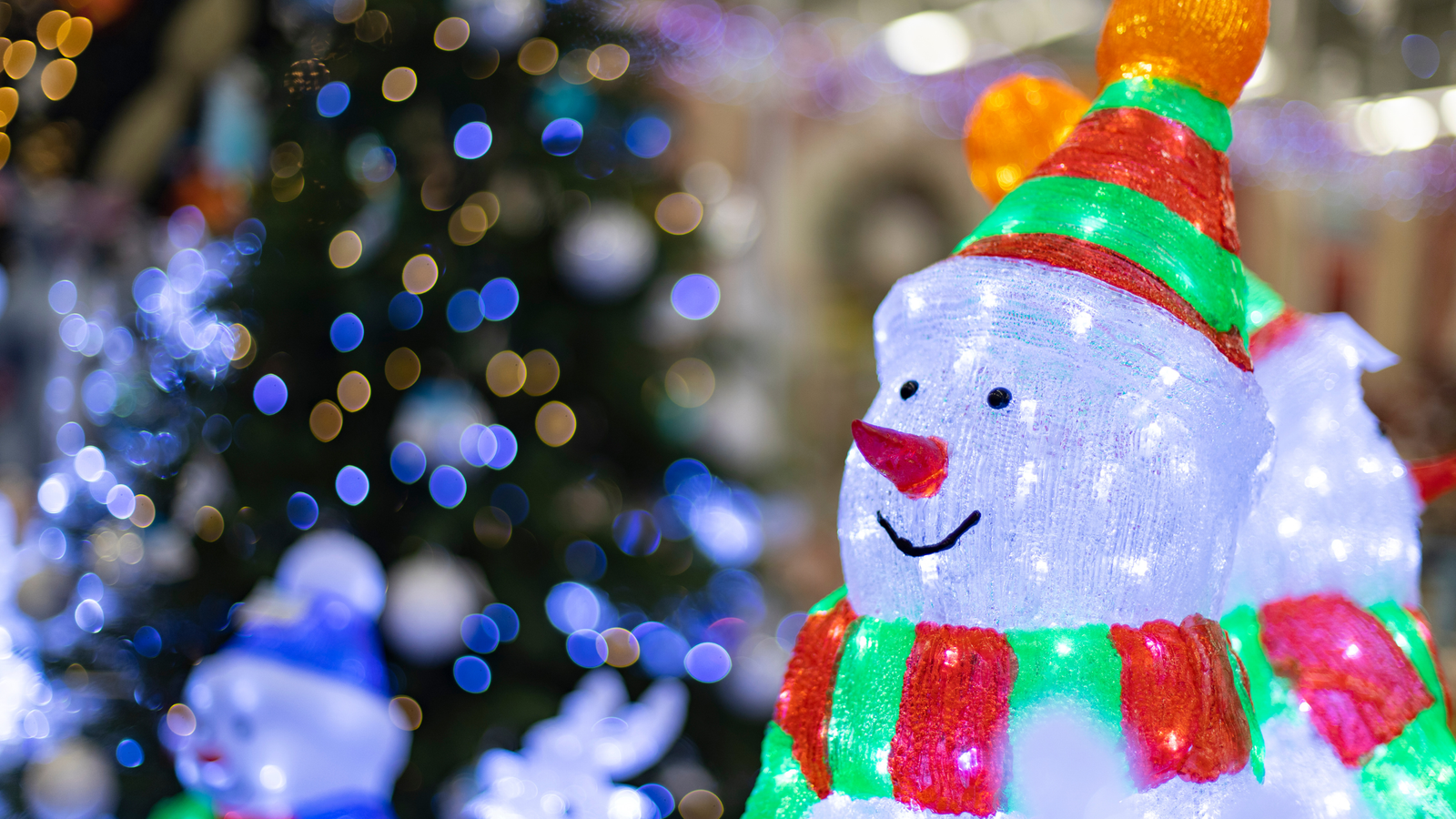 a white snowman with lights for christmas lighting design